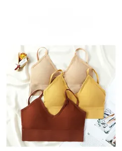 Detail of three seamless ribbed V-neck bras in beige, ginger, and reddish-brown colors