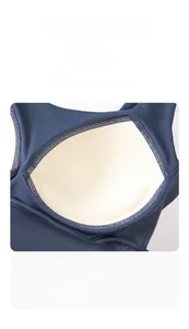 Detail of fixed beige pads with breathable honeycomb texture on blue sports bra