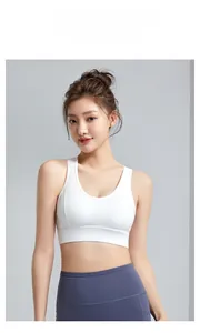 Close-up of a white U-neck sports bra and high-waist grey-blue leggings for yoga