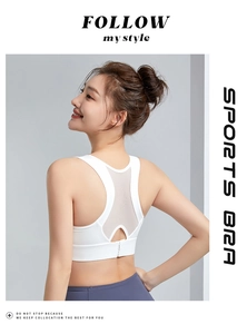 Close-up of white sports bra featuring breathable mesh racerback and metal clasp detail