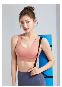 Nude pink wireless sports bra and high waist grey leggings set with blue yoga mat