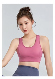Detail of pink sports bra with wide straps and high-waisted grey yoga leggings set