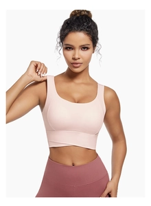 Close-up of pink sports bra featuring cross-over support hem and wide shoulder straps