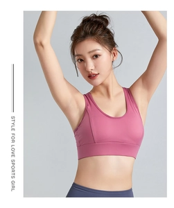 Detailed close-up of pink wireless sports bra with wide straps and U-neckline design