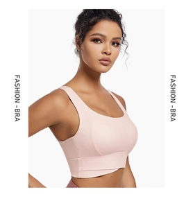 Detailed close-up of pink wireless sports bra with wide straps and fashion-bra text