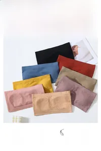 Flat lay of seamless wire-free bras in eight colors including black, blue, and nude