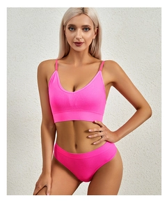 Detailed texture of seamless hot pink ribbed lingerie set with V-neck sports bra and brief