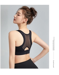 Detail of black sports bra featuring breathable mesh racerback and double-breasted closure