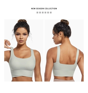 Sage green sports bra with wide straps and cross-over hem detail shown from front and back