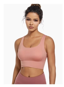 Detail of cross-over hem design on a dusty rose high-impact yoga sports bra for women