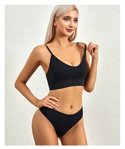 Detailed close-up of seamless black ribbed lingerie set featuring V-neck bra and high-cut panty