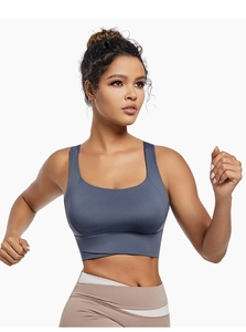 Detail of blue sports bra with wide straps and stylish cross-hem design for fitness