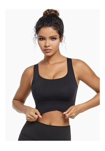 Detail of black sports bra with wide straps and unique cross hem design for yoga