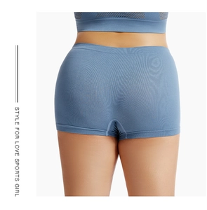Macro detail of high-waist seamless blue safety shorts with smooth hem and elastic fabric