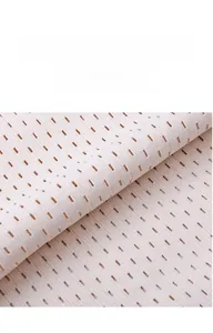 Close-up of beige breathable mesh fabric with elongated ventilation holes for comfort