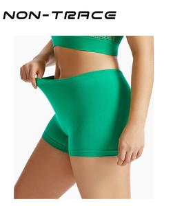 Close-up showing high elasticity of bright green seamless safety shorts with non-trace finish