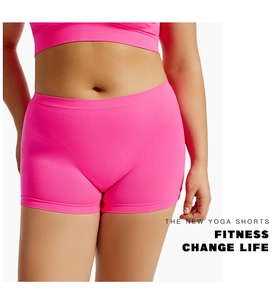 Detail of rose pink seamless yoga shorts with wide waistband on a fitness model
