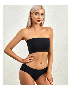 Close-up of black ribbed knit strapless bralette and matching panties set on model
