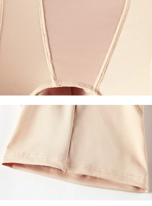 Detailed close-up of nude tummy control shapewear with breathable mesh and seamless stitching
