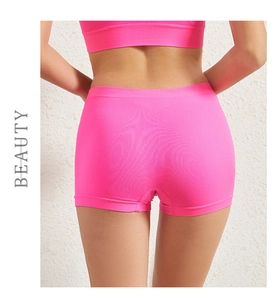 Detail of pink seamless high-waist yoga shorts with breathable knit texture for women