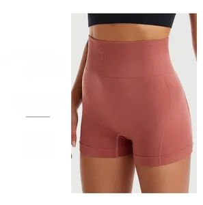 Macro shot of seamless high-waist yoga shorts in brick red with non-trace cutting detail