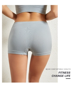 Close-up back view of seamless light gray boyshort fitness shorts in high-elasticity fabric