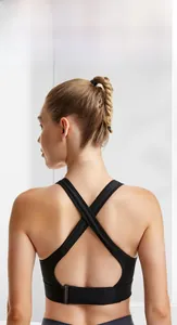 Detail of black sports bra featuring X-shaped cross back design and adjustable buckle