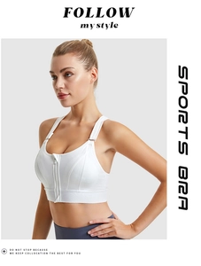 Detail of white sports bra featuring front zipper closure and adjustable shoulder straps