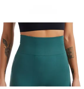 Close-up of high-waist yoga shorts in dark green with ribbed tummy control waistband