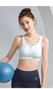 Close-up of white sports bra with front zipper and breathable honeycomb mesh fabric