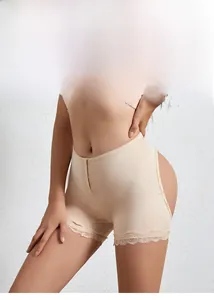 Detailed macro view of high-waisted beige shaper shorts with lace trim and hook-eye front closure