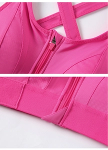 Detailed shot of front zipper closure and breathable mesh on rose red sports bra