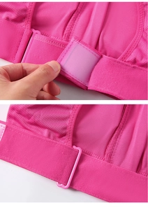Detail of rose red sports bra featuring breathable mesh fabric and adjustable velcro straps