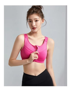 Front zipper close-up on high-impact rose pink sports bra with wide shoulder straps