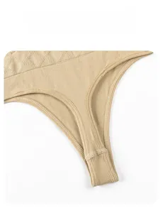 Close-up of the breathable diamond-knit fabric and seams of the nude shapewear thong