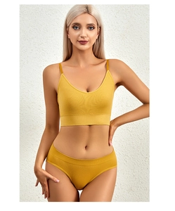 Detail of mustard yellow ribbed seamless lingerie set with thin straps on a model