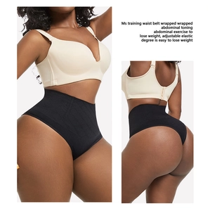 Detail view of high waist black tummy control thong showing seamless compression fabric