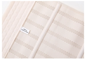 Detail view of breathable waist trainer fabric with supportive bones and size L label