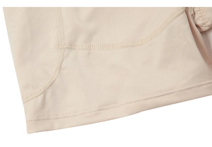 Macro view of high-waist body shaper shorts showing precise flat seam stitching detail