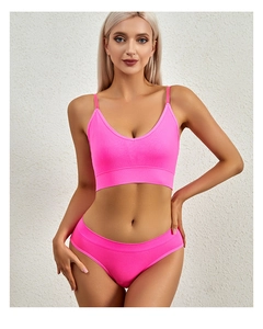 Pink rib-knit lingerie set with V-neck camisole and high-waist panty on model