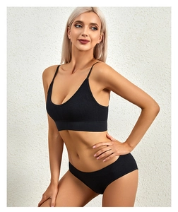 Detail of black ribbed knit lingerie set featuring thin straps and high-stretch fabric