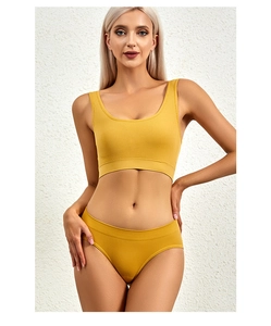 Front view of a yellow ribbed knit wireless bra and matching seamless panty set