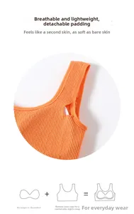 Detailed close-up of orange ribbed sports bra with removable pads and breathable fabric