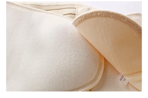 Close-up of beige waist trainer featuring soft fabric texture and velcro strap detail