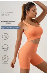 Detail of orange ribbed sports bra and high-waist shorts set showing texture and supportive fit