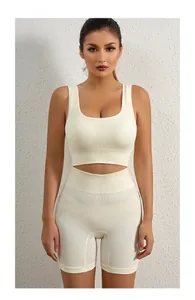 Detail of cream ribbed two-piece yoga set featuring high-waist shorts and U-neck tank top