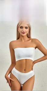 Close-up of white seamless ribbed bandeau bra and panty set on a natural background