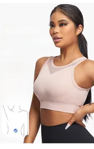 Detail view of pink high-stretch seamless sports bra with V-shaped breathable mesh texture