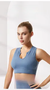 Detail of high-stretch ribbed fabric and wide hem support on the grey-blue sports bra