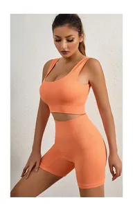 Detail of ribbed texture and high-waist fit on bright orange fitness sports set